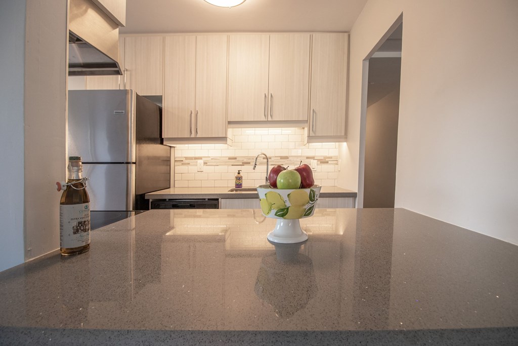 a kitchen counter with a bowl of fruit on it
