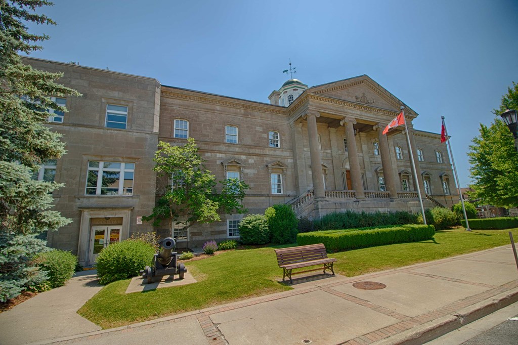 a building with a statue and a lawn in front of it