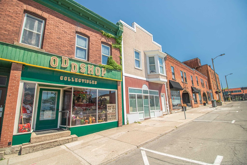 a row of shops on the side of a street