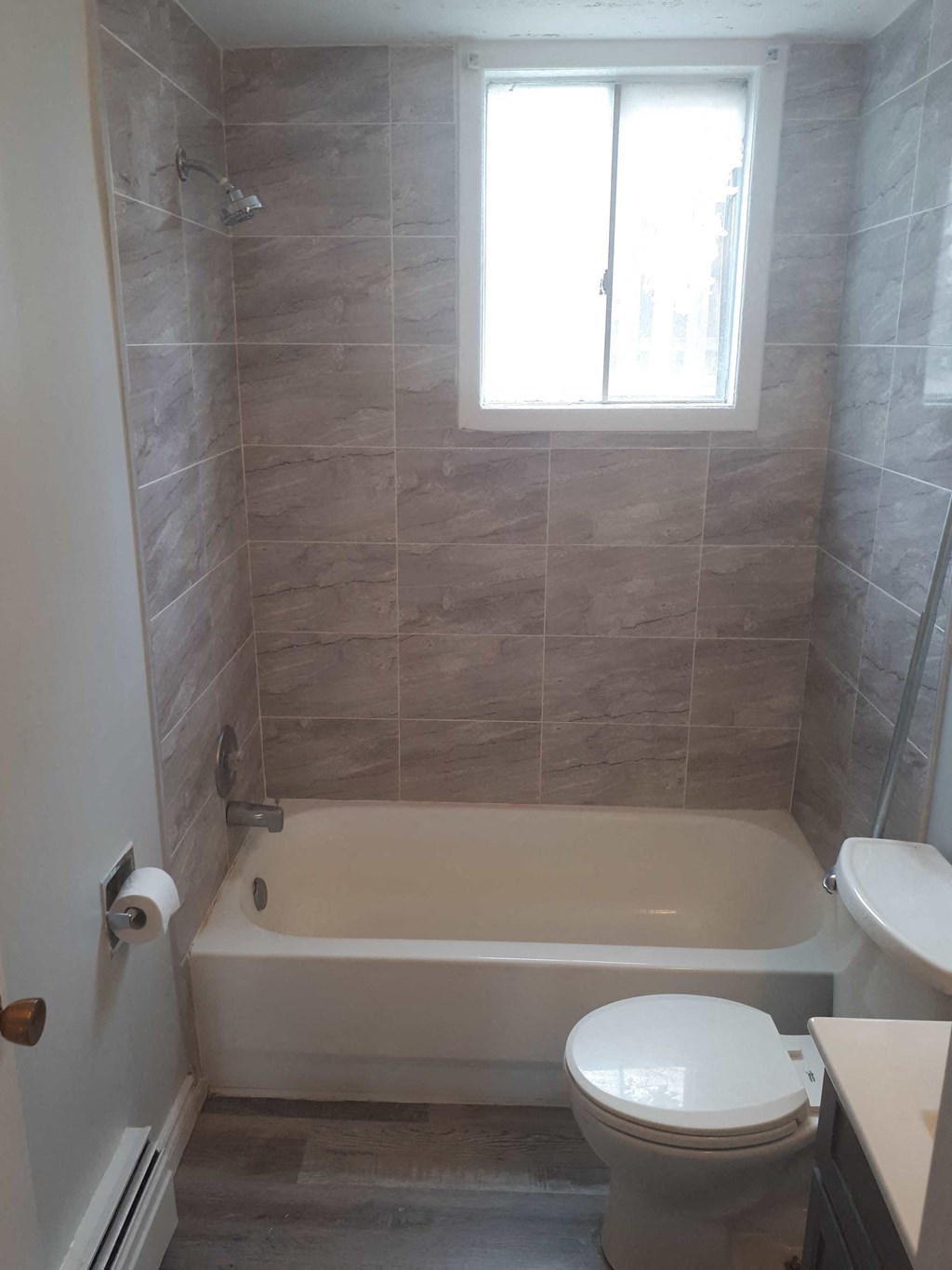 a small bathroom with a toilet and a bath tub