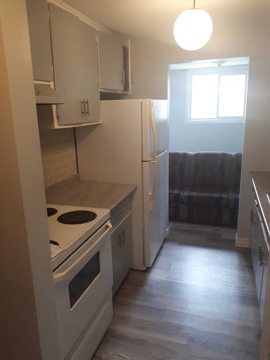a kitchen with a stove and a refrigerator