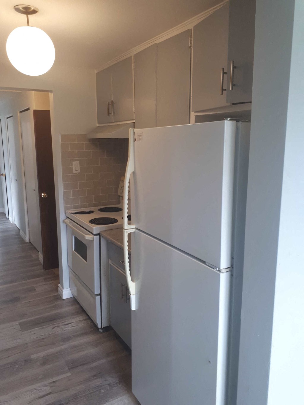 a kitchen with a refrigerator and a stove in it