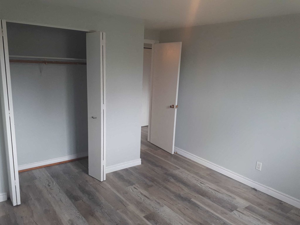 a room with wood floors and a closet