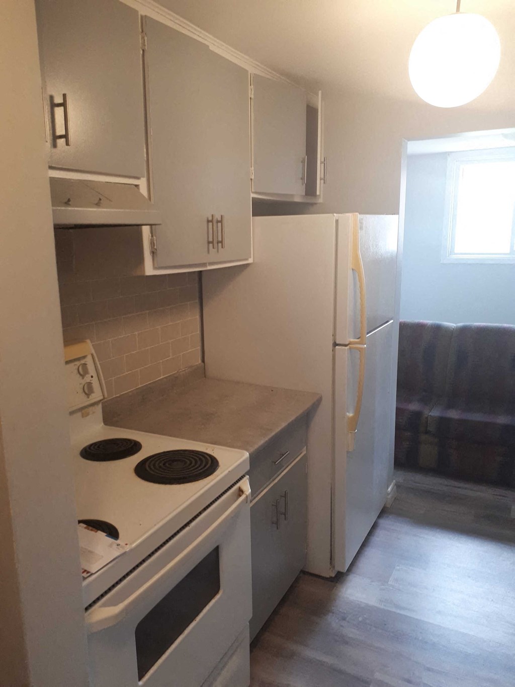 a kitchen with a stove and a refrigerator