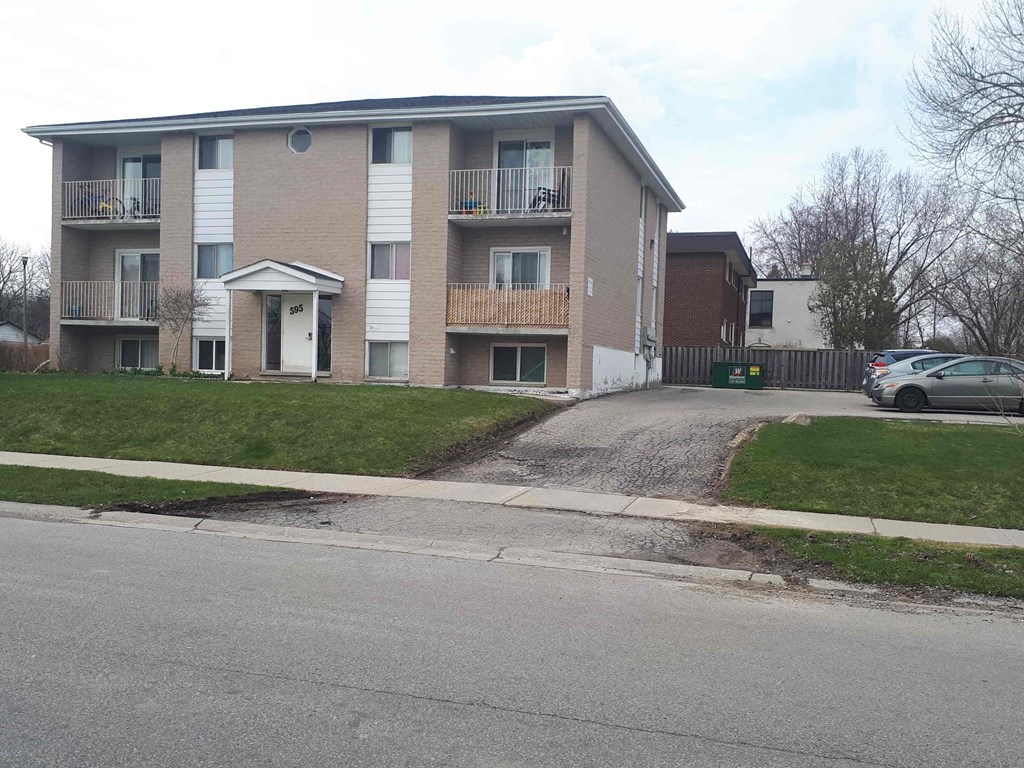 an apartment building on the side of a street