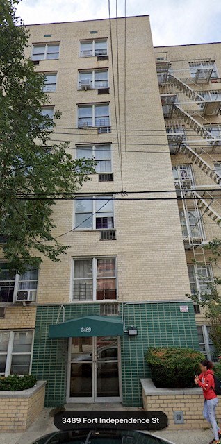 A building with a green awning and the number 3489 on it.