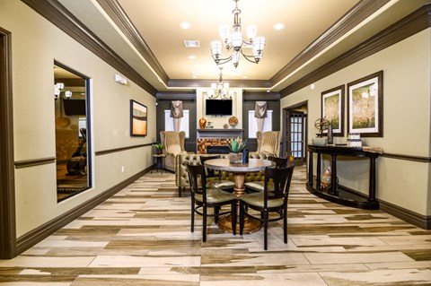 A dining room with a table set for six.