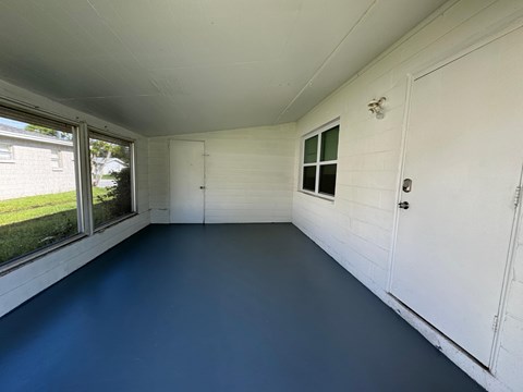 the interior of a home with a blue floor and white walls