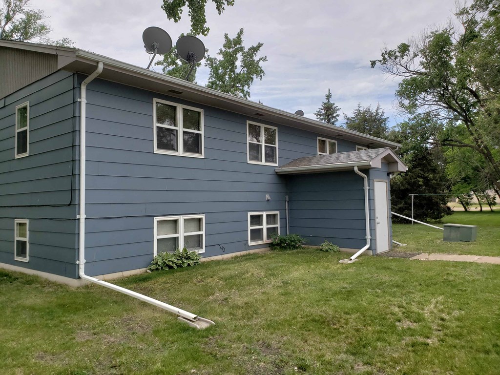 a blue house with two satellite dishes on the roof