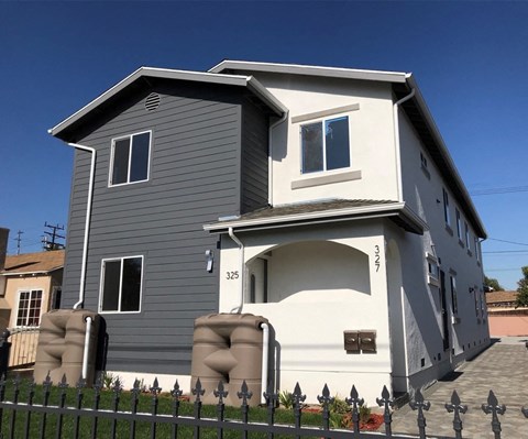 A two-story house with a grey exterior and white trim.