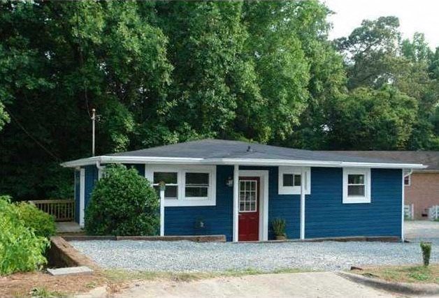 a blue and white house with a red door