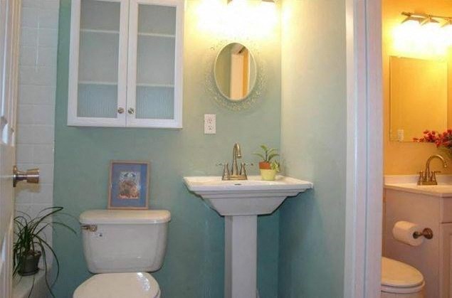 a bathroom with a sink toilet and a mirror