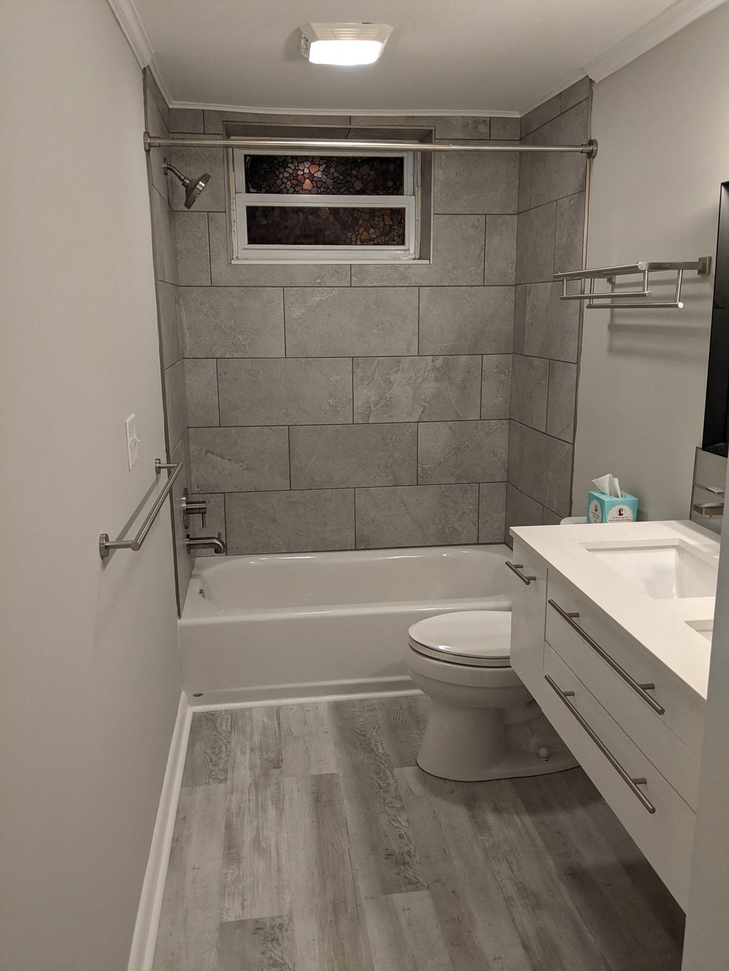 A bathroom with a toilet, sink, and bathtub.