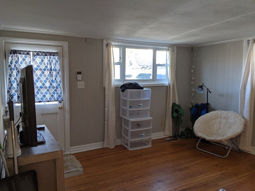 A room with a chair and a window.