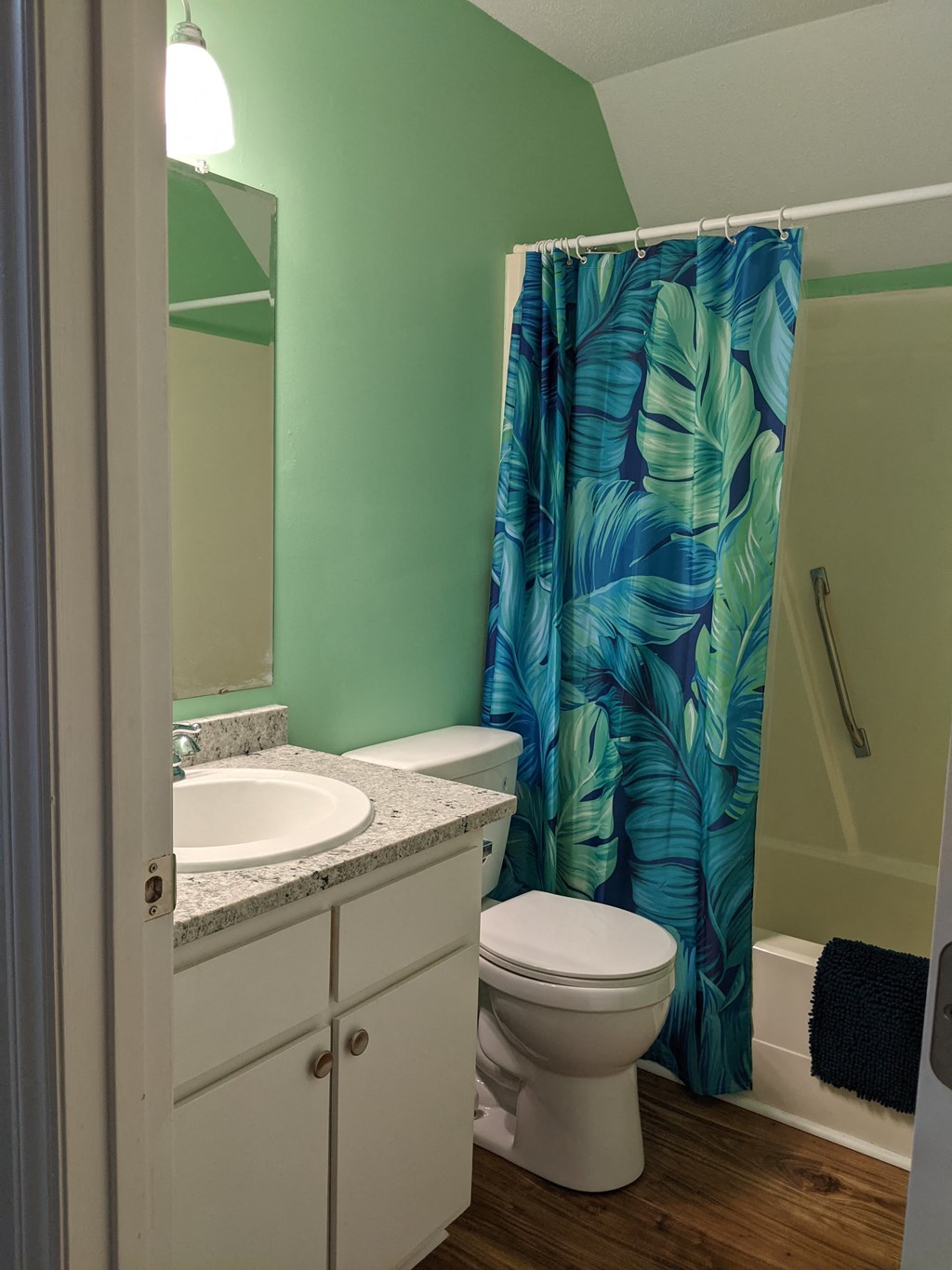 A white toilet sits next to a sink in a bathroom.