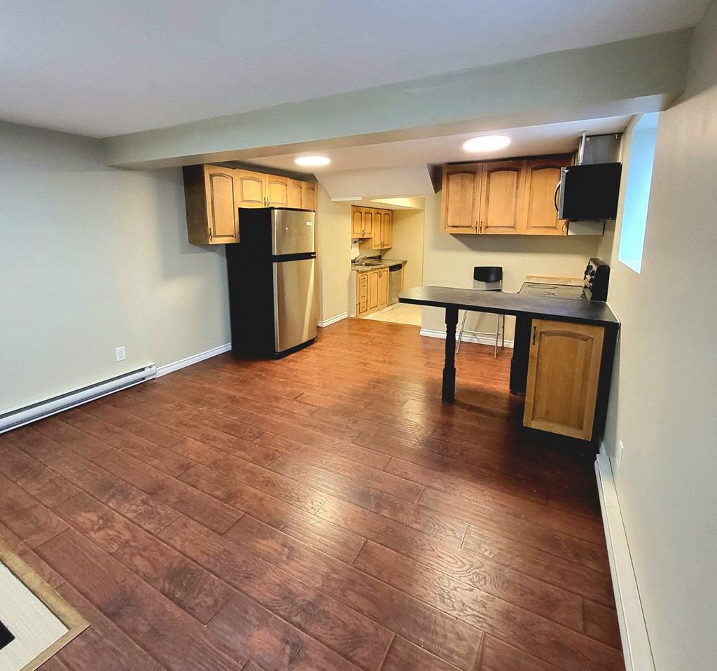 a kitchen and living room with wood flooring and
