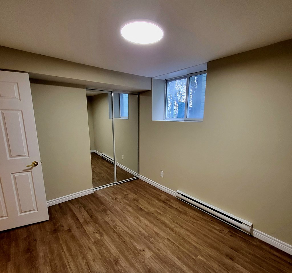 an empty room with a door and a window