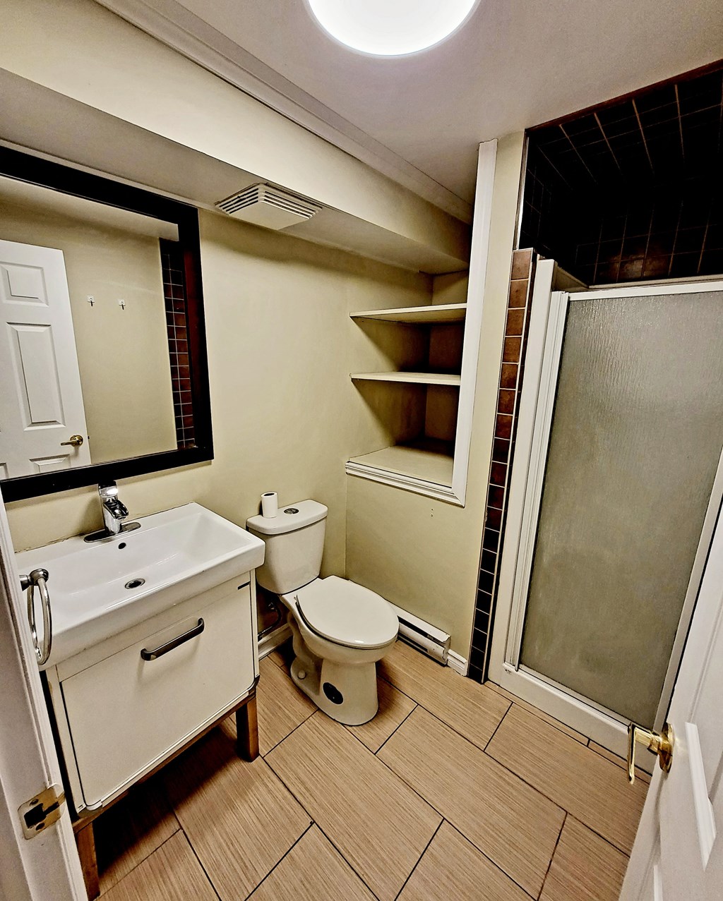 a bathroom with a toilet and a sink and a shower