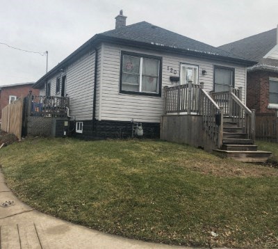 a white house with a yard and stairs
