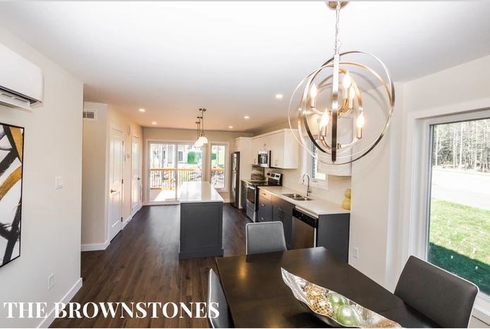 a kitchen and dining room with a table and chairs