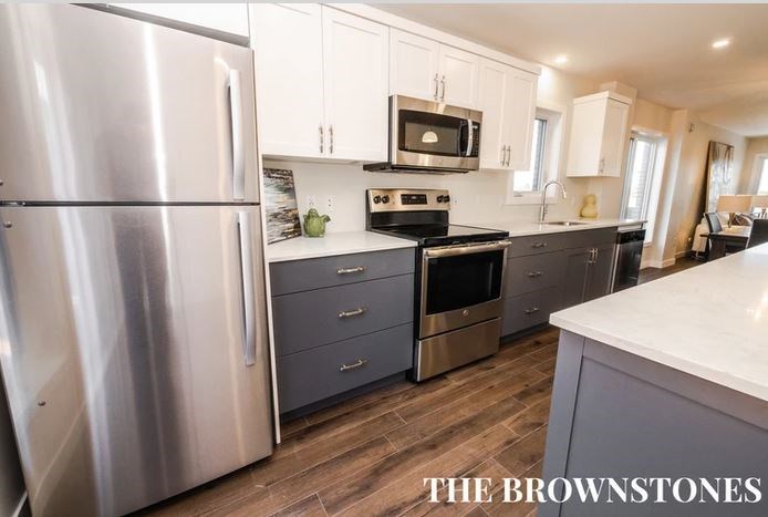 a kitchen with stainless steel appliances and white cabinets