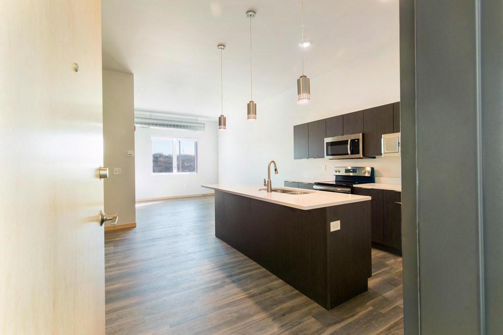 an empty kitchen with a large island in the middle