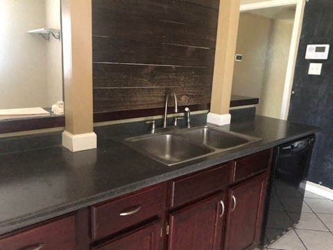 a kitchen with a sink and a mirror