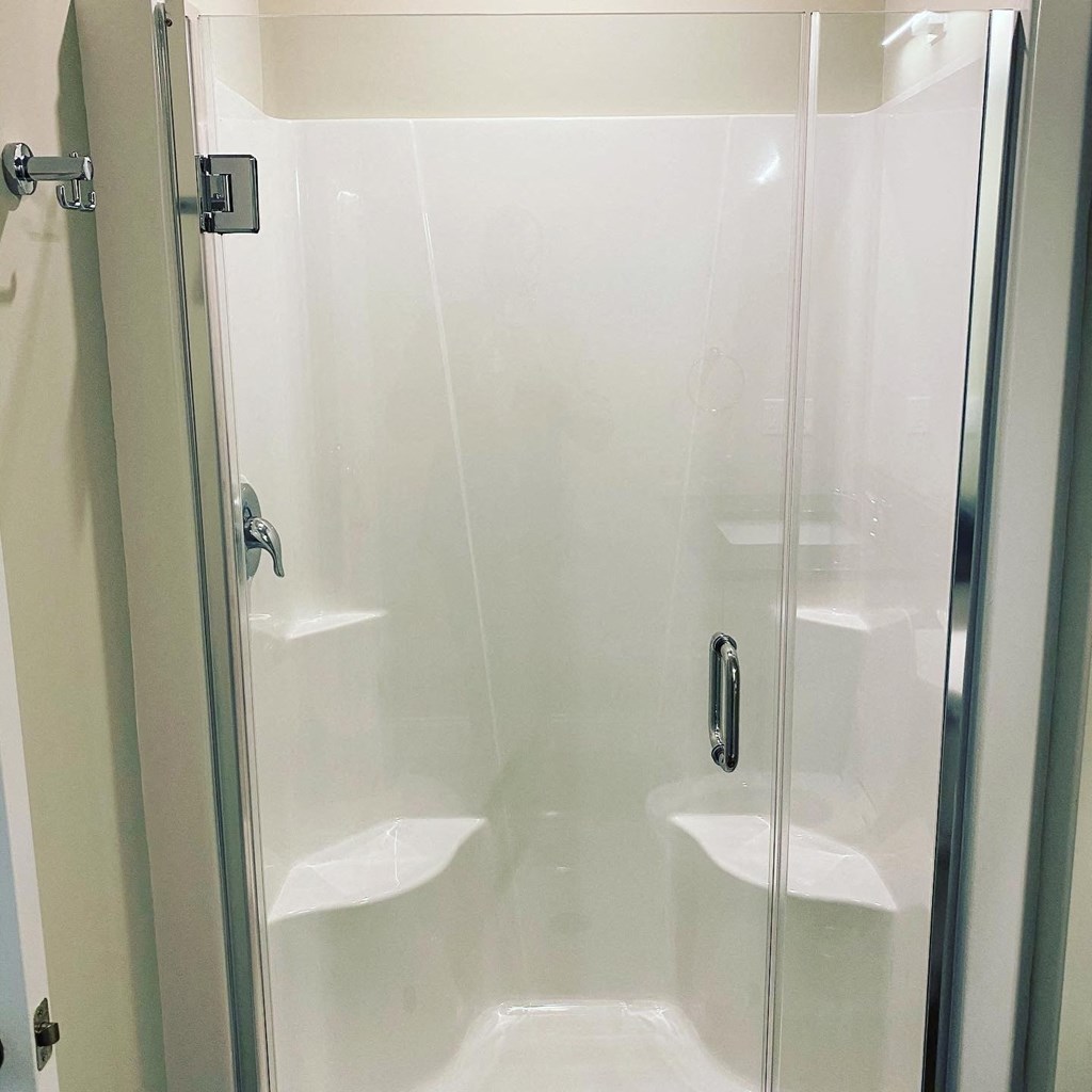 a shower in a bathroom with a glass door