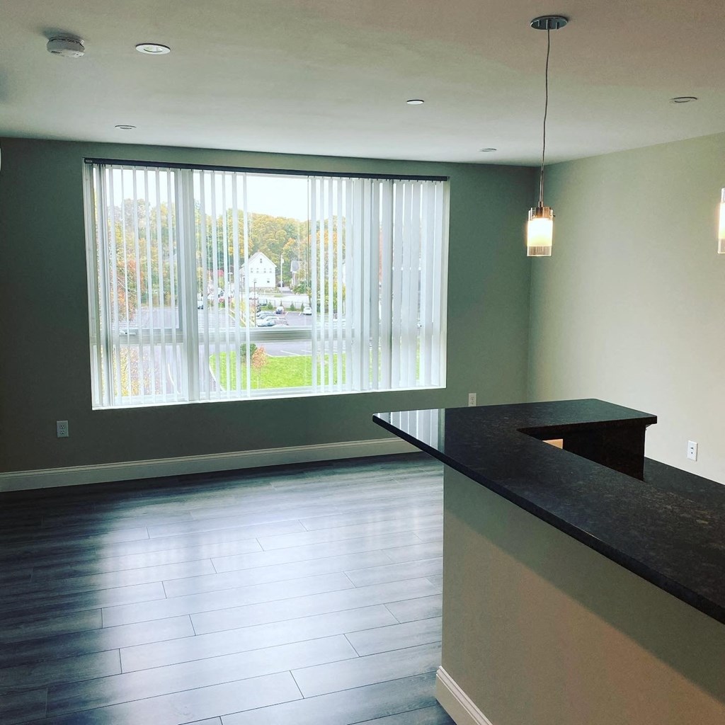 an empty living room with a large window