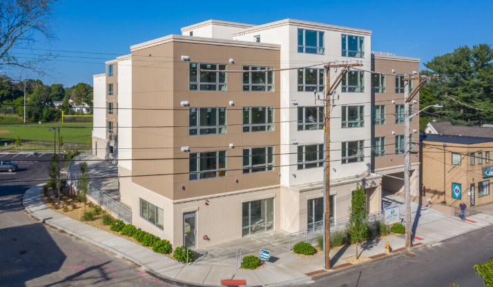 an aerial view of an apartment building on a city street