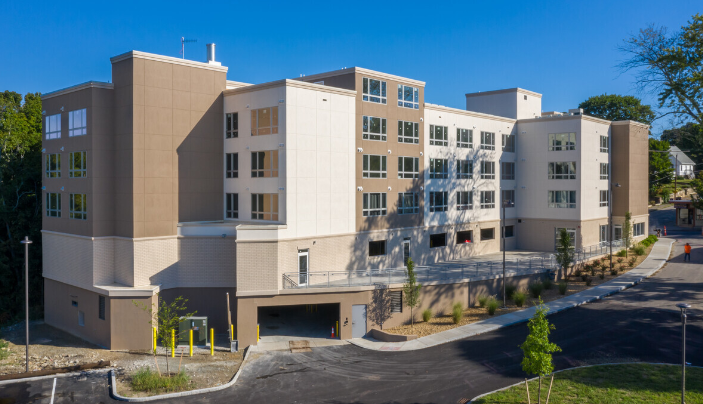 a new apartment building with a street in front of it