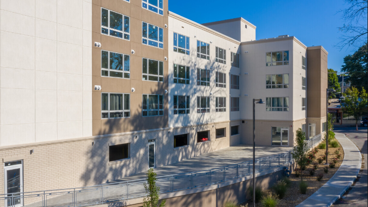 an exterior view of a building with a street and a sidewalk