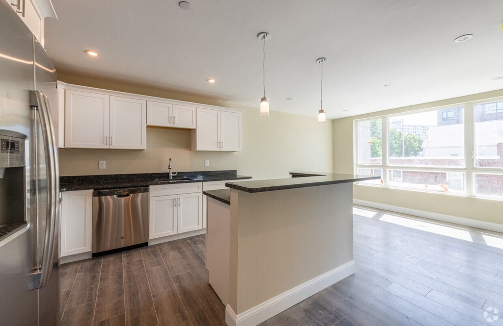 a kitchen with white cabinets and a counter top