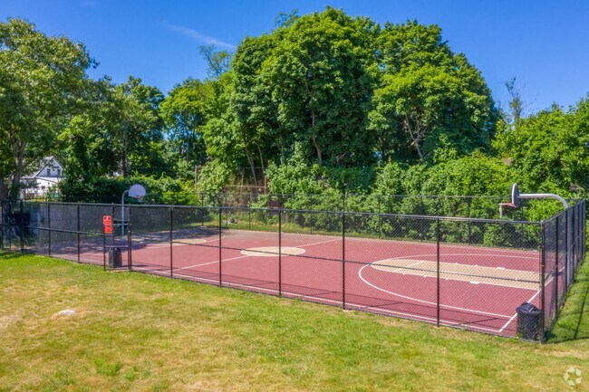 a tennis court with a chain link fence around it