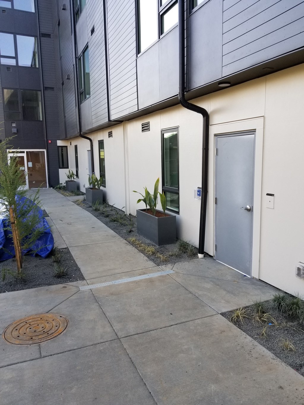 a sidewalk in front of a building with a door