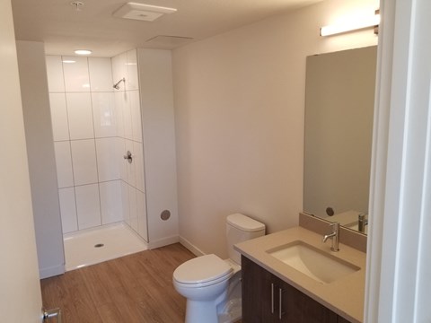 a bathroom with a toilet and a sink and a shower