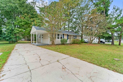 A house with a front yard and a driveway.