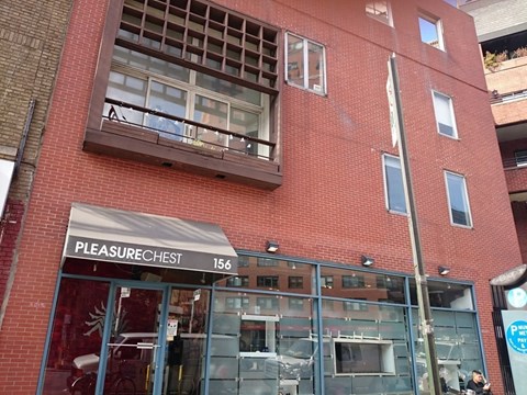 A red brick building with a store front called Pleasure Chest.