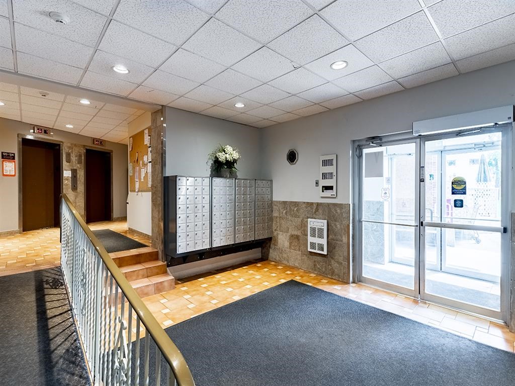 the lobby of a building with glass doors