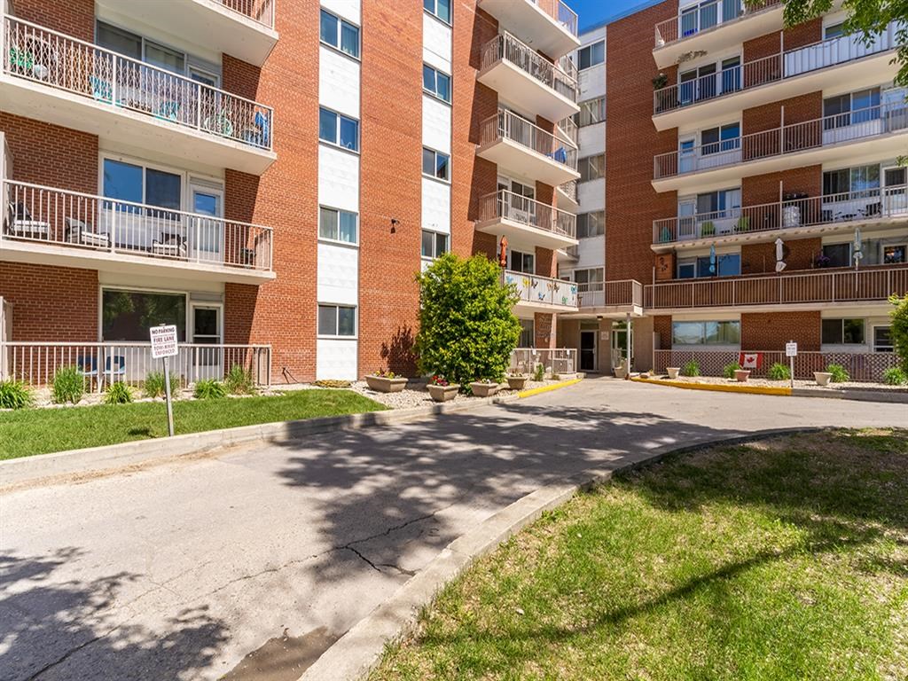 an apartment building with a street in front of it