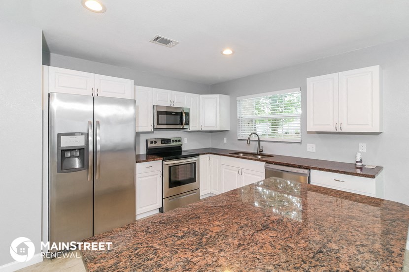 the kitchen is updated with stainless steel appliances and granite counter tops