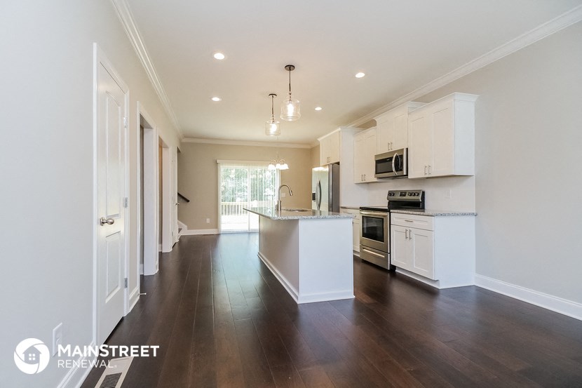 a kitchen with white cabinets and a white counter top