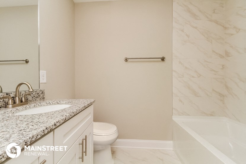 a bathroom with a sink and a toilet and a bath tub