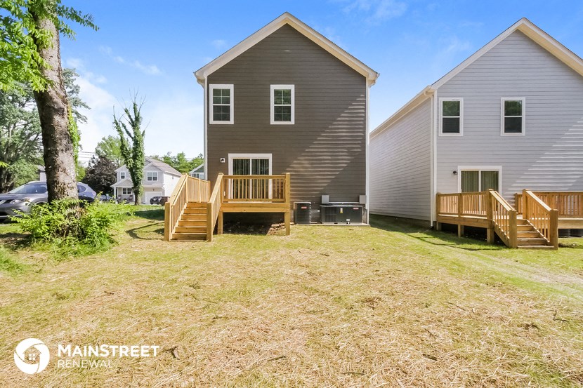 a backyard with a house and a porch and a deck