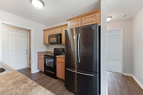 a kitchen with black appliances and wooden cabinets