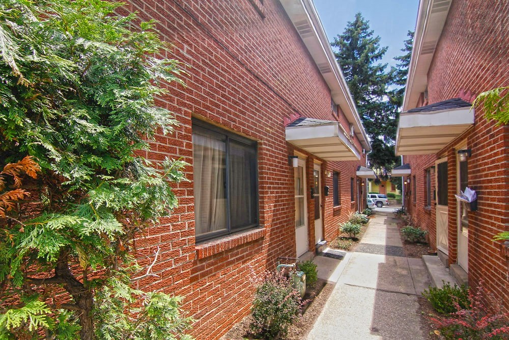 a brick building with a sidewalk in front of it