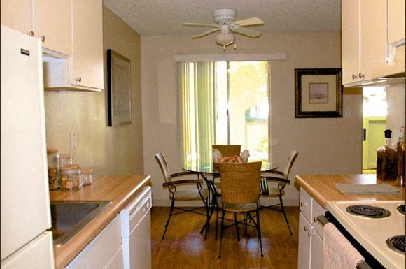 a kitchen and dining room with a table and chairs