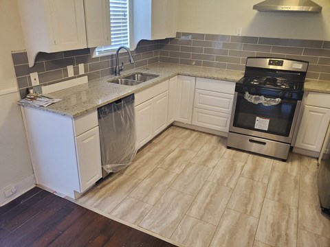 A kitchen with a stove top oven and a dishwasher.
