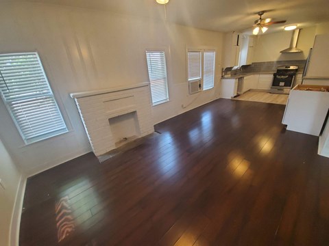 A room with wooden floors and a fireplace.