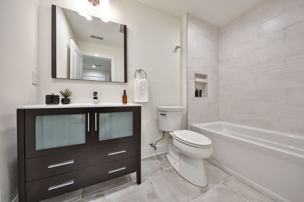 a bathroom with a toilet and a sink and a bath tub